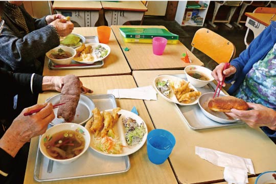 When grown-ups miss school lunch, there is a cafeteria that serves school lunches in a room replicating an elementary school classroom. School lunch always brings up nostalgia.