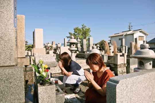 A typical scene of a Japanese graveyard visit.