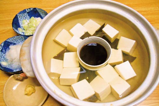 Piping hot Yudofu is served with warmed dipping sauce.